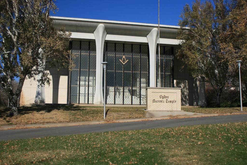 A glass-and-metal-fronted modernist version of a Roman temple, with a G enclosed within a compass and square mounted on the front.